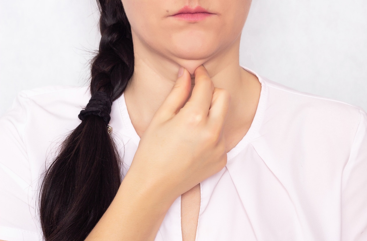 Caucasian beautiful girl pulls her hand off a double fat chin, a problem with a hanging chin, white background