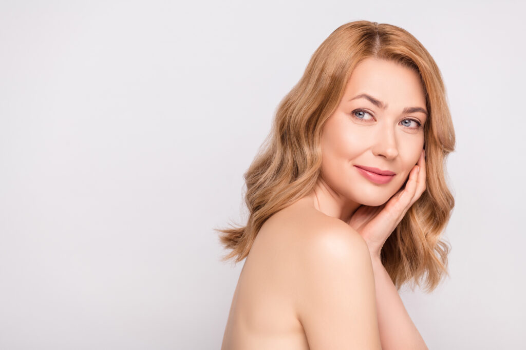 Woman poses to show off her full hair and great skin